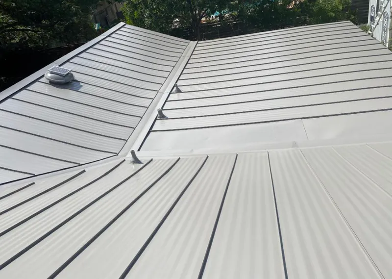 Solar attic fan installed on a metal roof for Roof Ventilation in Black Forest
